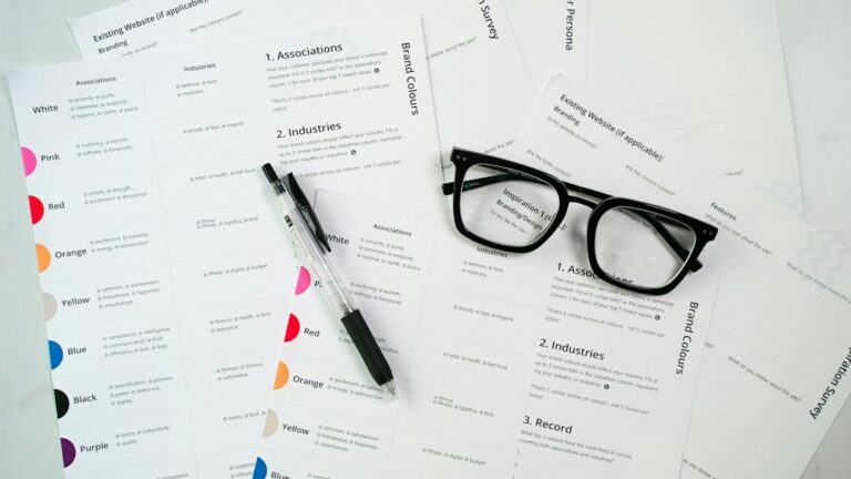 Glasses and a pen resting on paperwork.