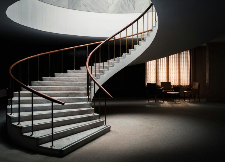 A spiral staircase curving around an open center.