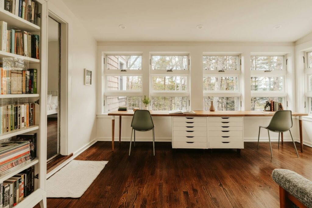 Two workspaces sharing a bright room at home.