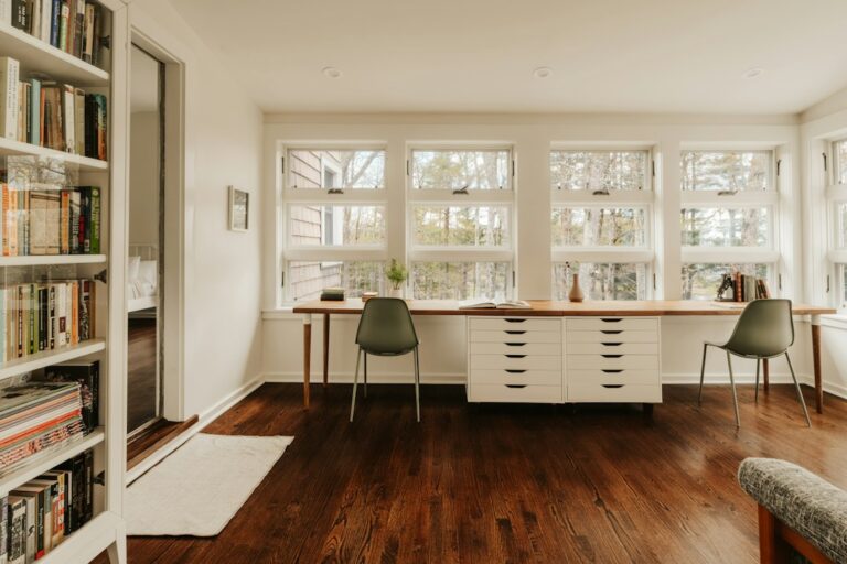 Two workspaces sharing a bright room at home.