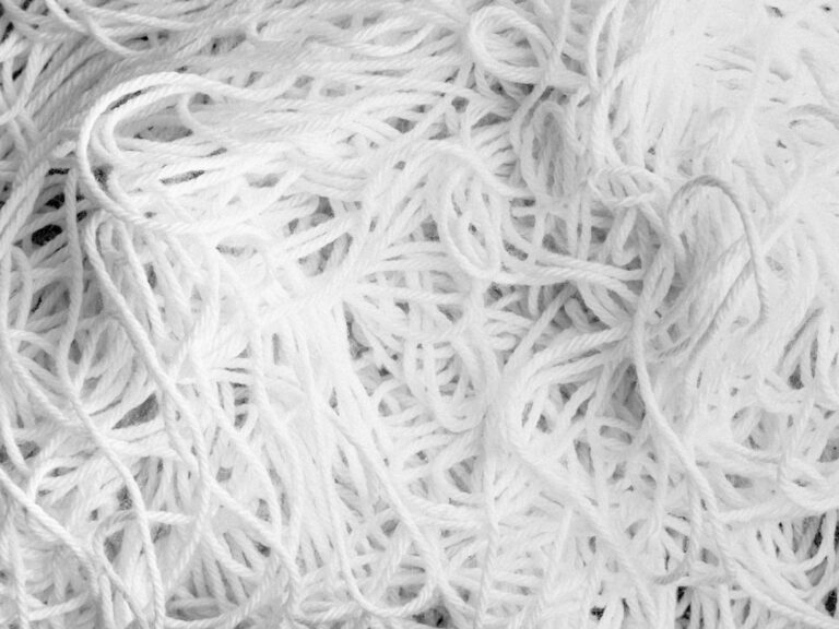 Overlapping strands of yarn, photographed in black and white.